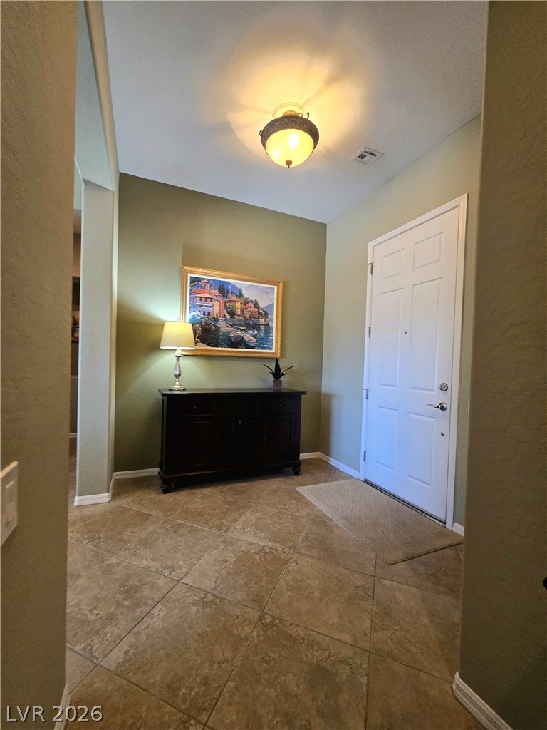 2567 Dirleton Place Henderson, NV 89044 - Photo 27 of 67 A welcoming entry, with durable tile flooring and a bright overhead light, invites you further inside.