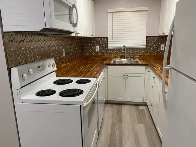 a utility room with sink dryer and washer