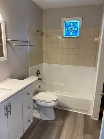 a bathroom with a toilet a sink and bathtub