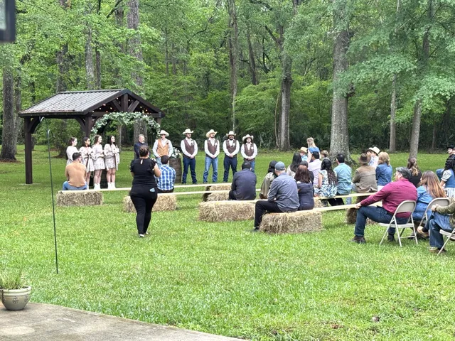 a group of people sitting in a yard