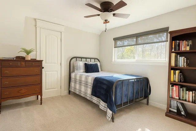 a bedroom with a bed and a book shelf