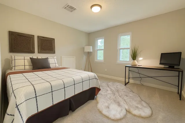 a bedroom with a bed and window