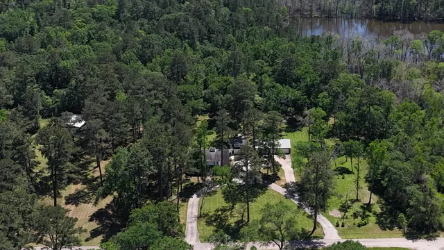 an aerial view of residential house with outdoor space and trees