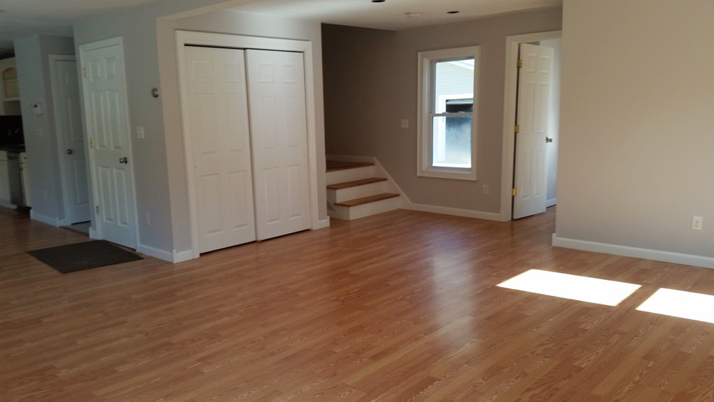 423 Putnam Hill Road Sutton, MA 01590 - Photo 4 of 12 a view of a hallway with wooden floor and stairs