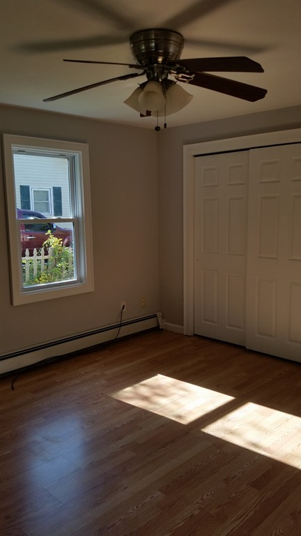 423 Putnam Hill Road Sutton, MA 01590 - Photo 8 of 12 a view of an empty room with wooden floor and a window