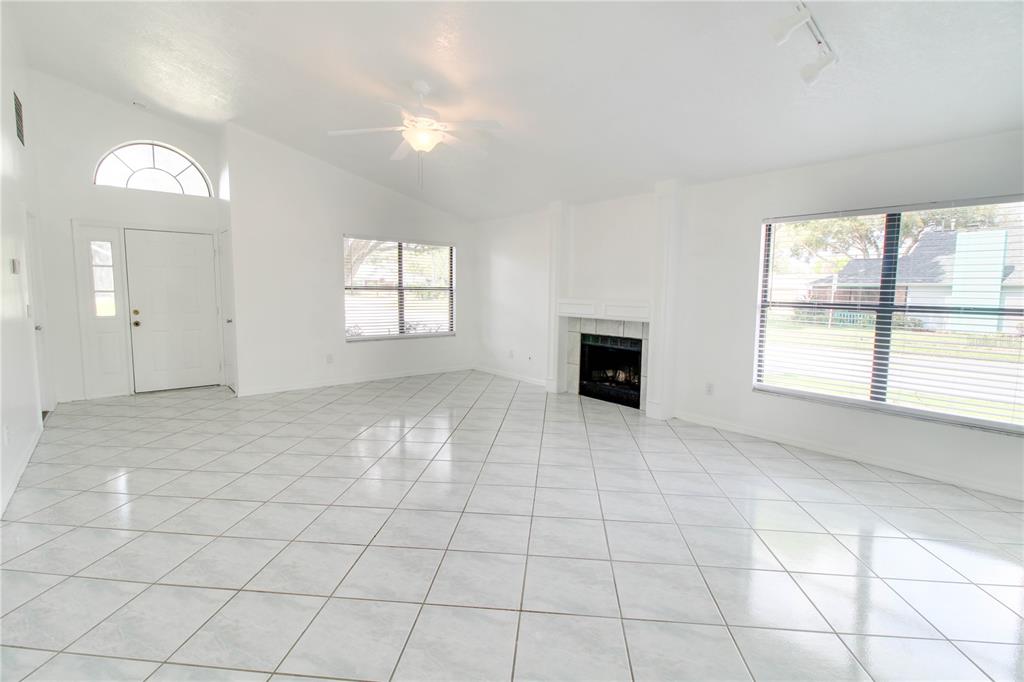 3107 Ash Park Loop Winter Park, FL 32792 - Photo 3 of 11 an empty room with windows and fireplace