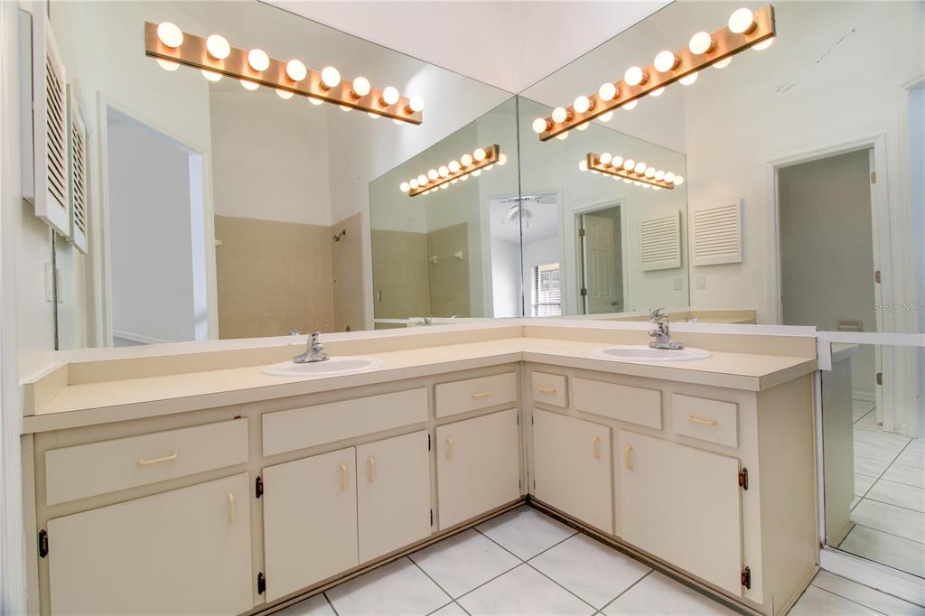 3107 Ash Park Loop Winter Park, FL 32792 - Photo 7 of 11 a spacious bathroom with a double vanity sink a mirror and a shower
