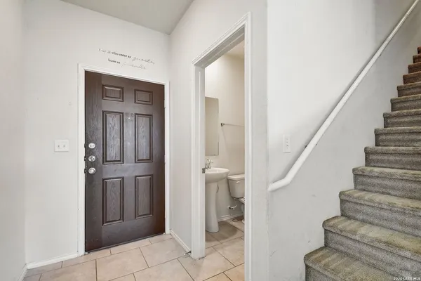 a view of entryway with bathroom and stairs