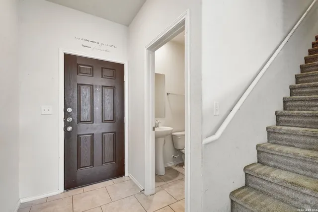 a view of entryway with bathroom and stairs