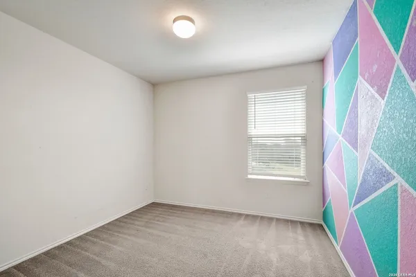 a view of a house with wooden fence and large windows