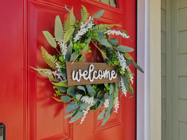 a kitchen with stainless steel appliances granite countertop a refrigerator a stove a sink dishwasher and a oven with wooden floor