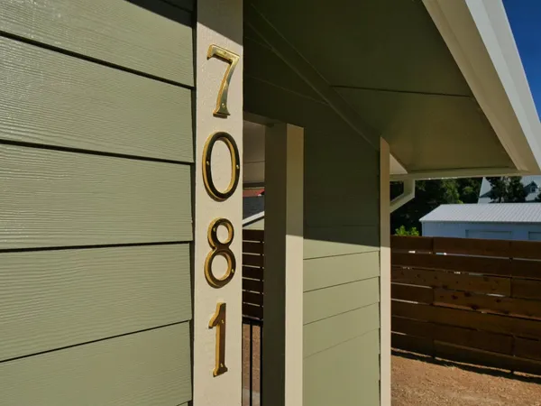 a large kitchen with stainless steel appliances kitchen island granite countertop a refrigerator and a stove top oven