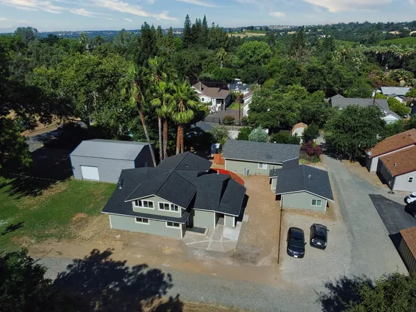 an aerial view of a house with a yard