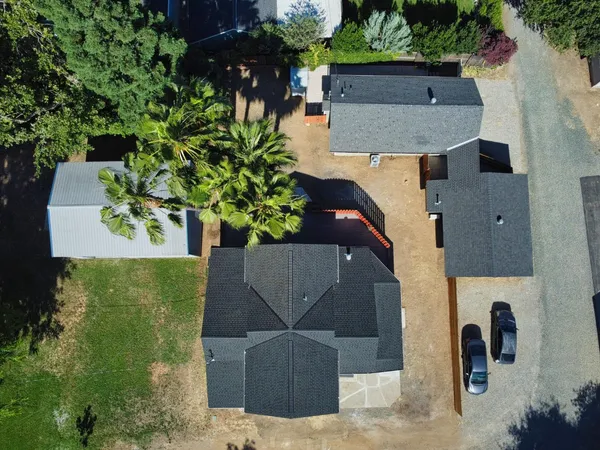 an aerial view of a house with garden space and street view
