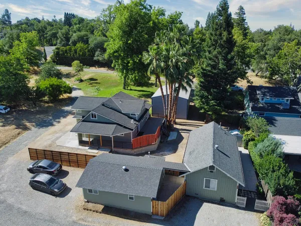 an aerial view of a house with a yard