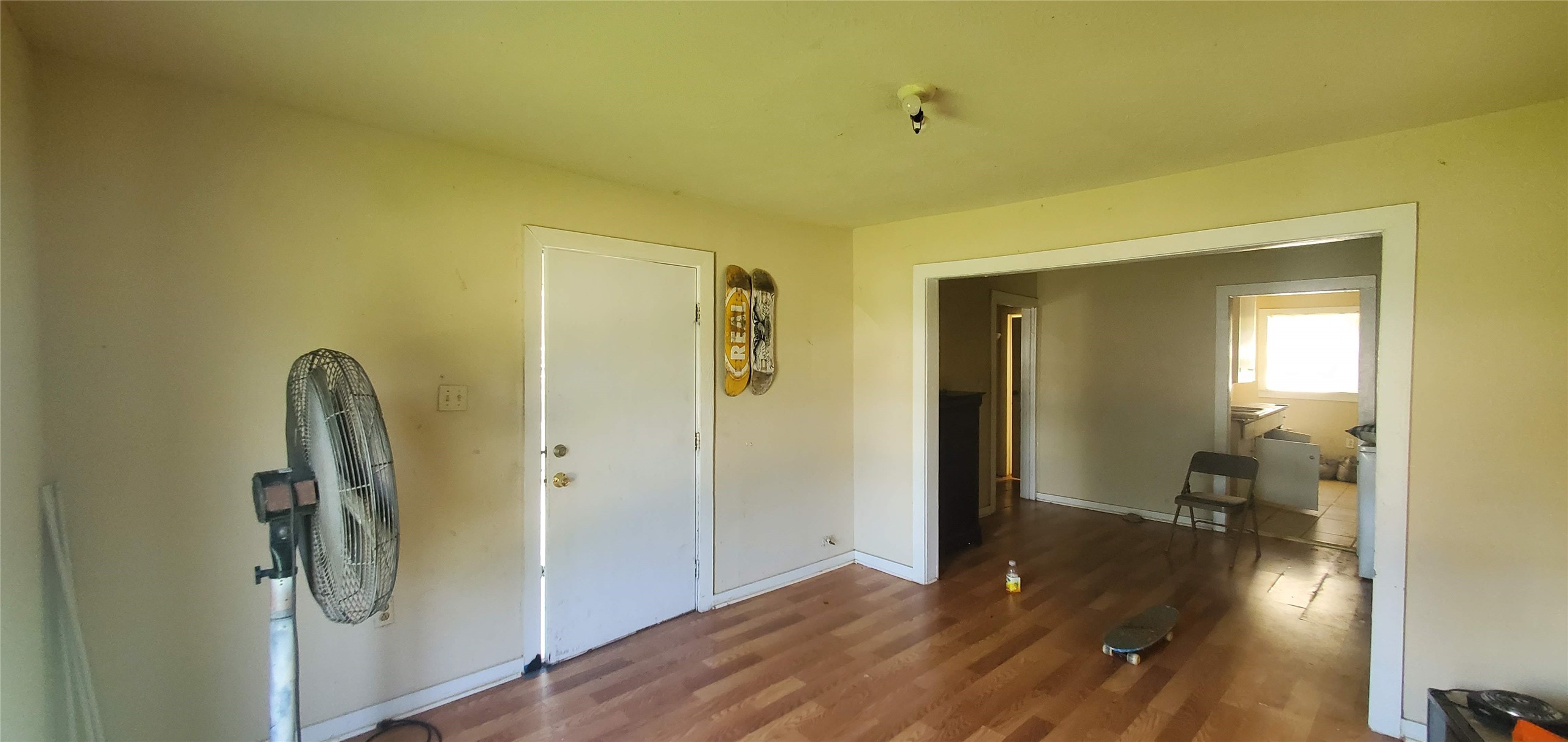 7328 Parkes Street Houston, TX 77088 - Photo 5 of 12 a view of a hallway with wooden floor and a living room