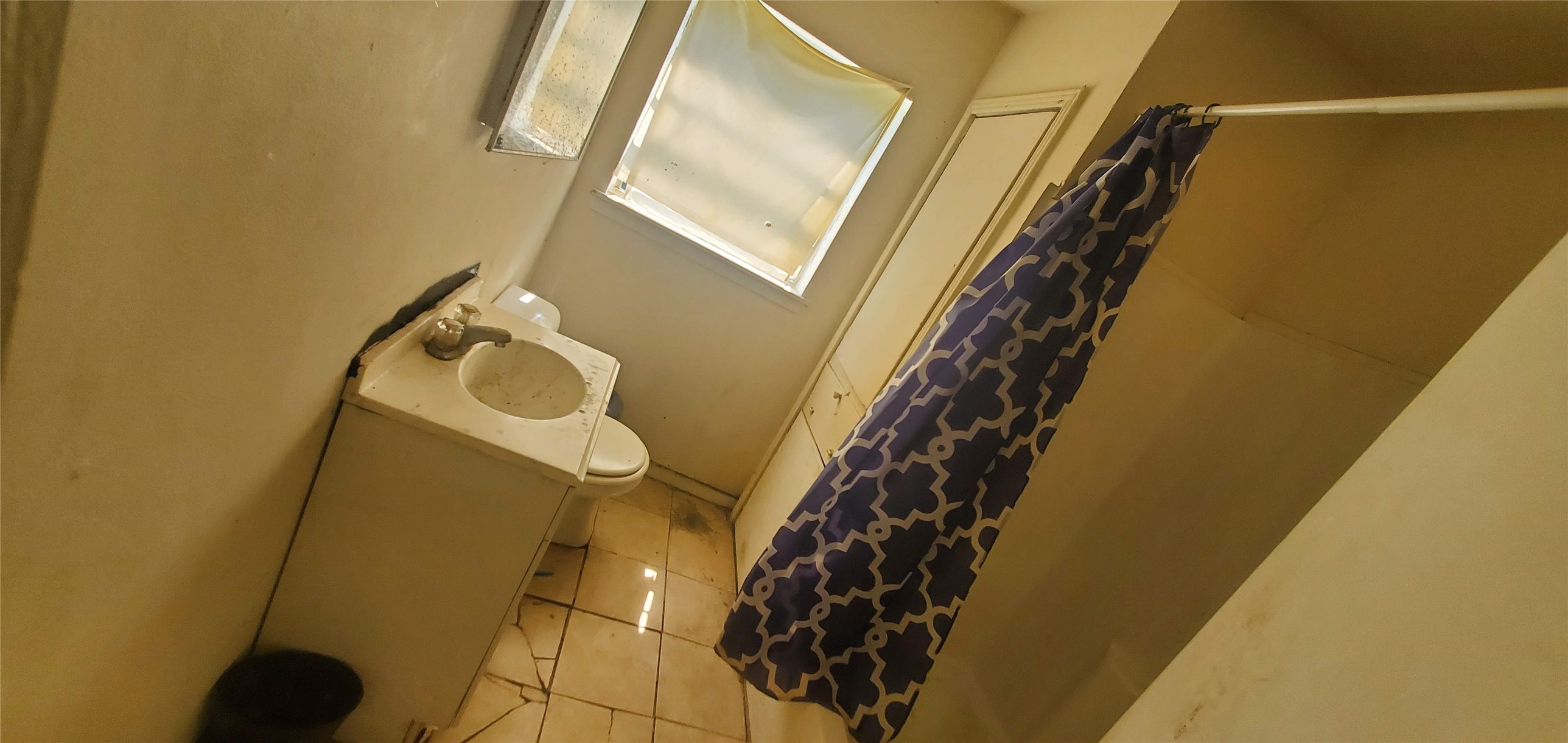 7328 Parkes Street Houston, TX 77088 - Photo 10 of 12 a bathroom with a sink and a mirror