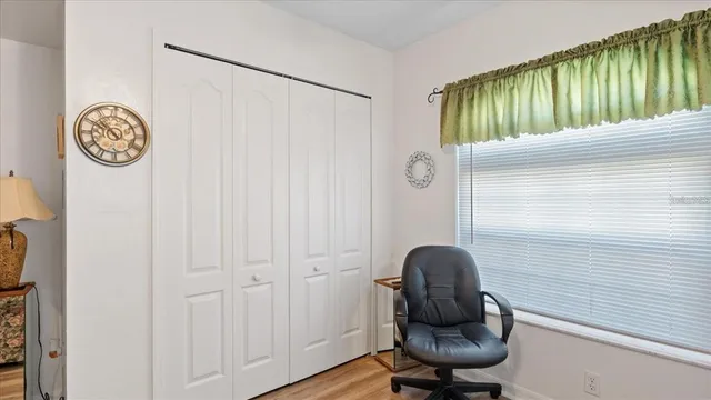 a view of a hallway with a window and bathroom