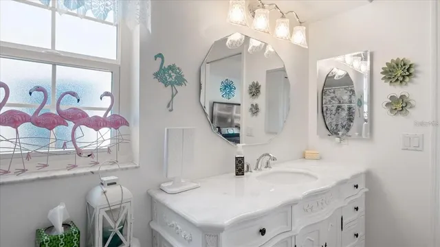 a bathroom with a double vanity sink and a mirror