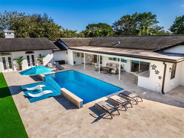 a view of a patio with table and chairs with wooden floor and fence
