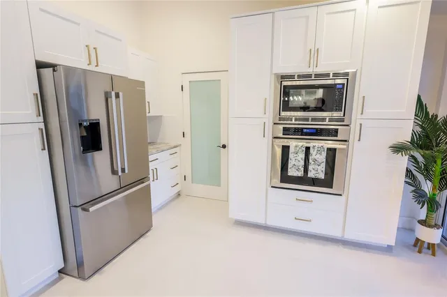 a kitchen with stainless steel appliances a refrigerator a microwave and a stove