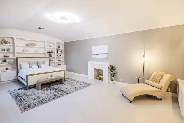 a bedroom with a bed and a couch