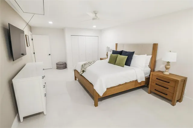 a bedroom with a bed and a flat screen tv