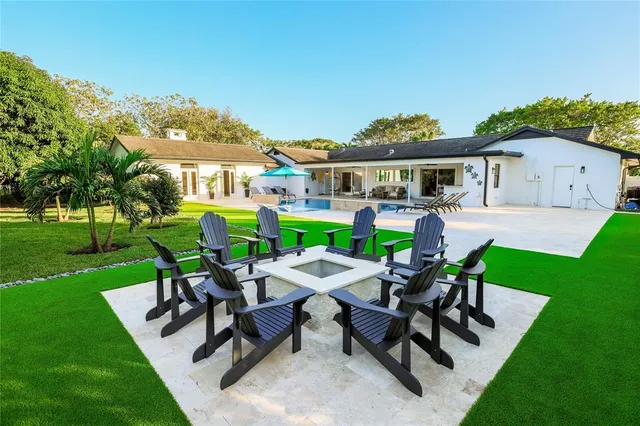 a view of a patio with table and chairs and potted plants