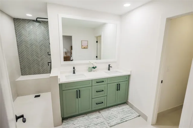 a bathroom with a double vanity sink mirror and