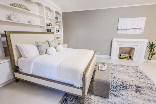 a bedroom with a bed and a fireplace