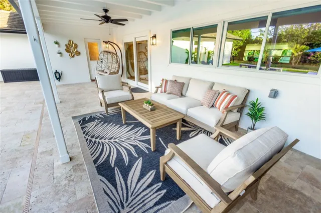 a living room with furniture and a large window