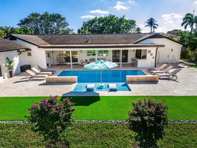 a front view of house with yard and outdoor seating