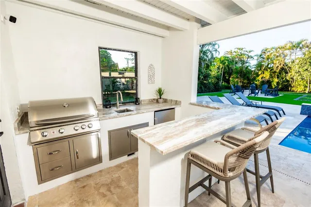 a swimming pool with outdoor seating and a yard