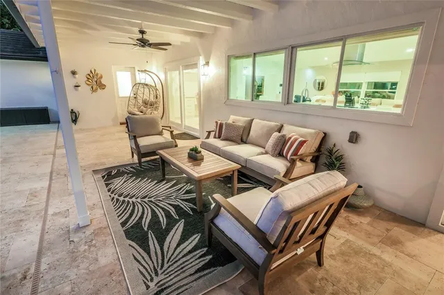 a view of a house with a yard and potted plants