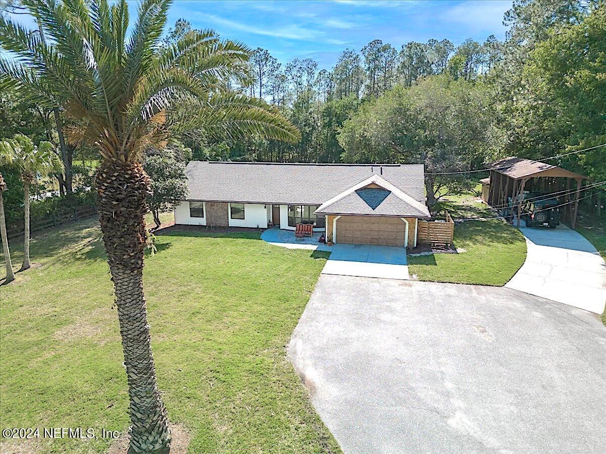 1355 Roberts Road St. Johns, FL 32259 - Photo 3 of 45 a view of house with garden space and trees