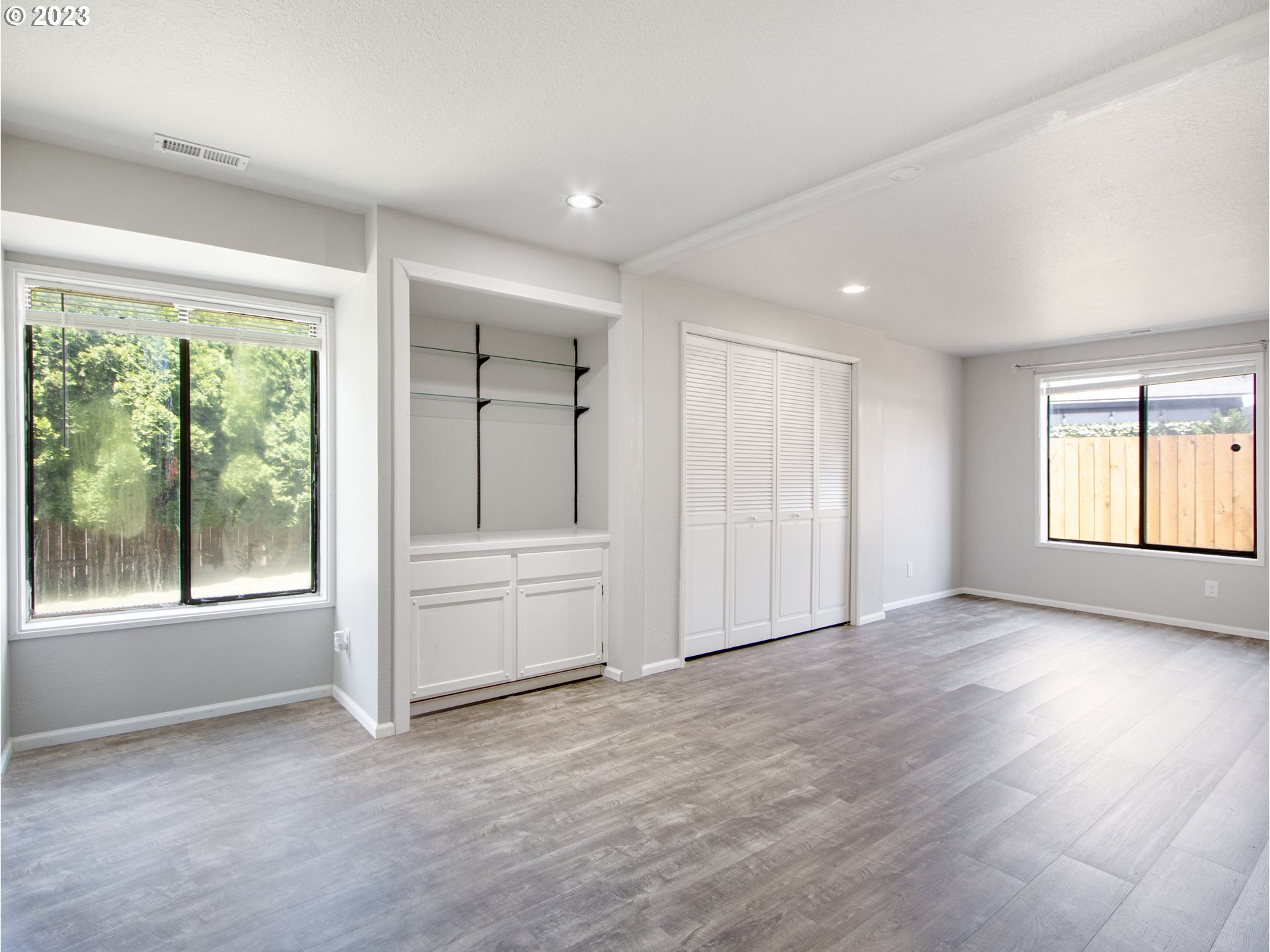 2883 Elysium Avenue Eugene, OR 97401 - Photo 11 of 21 an empty room with wooden floor and windows