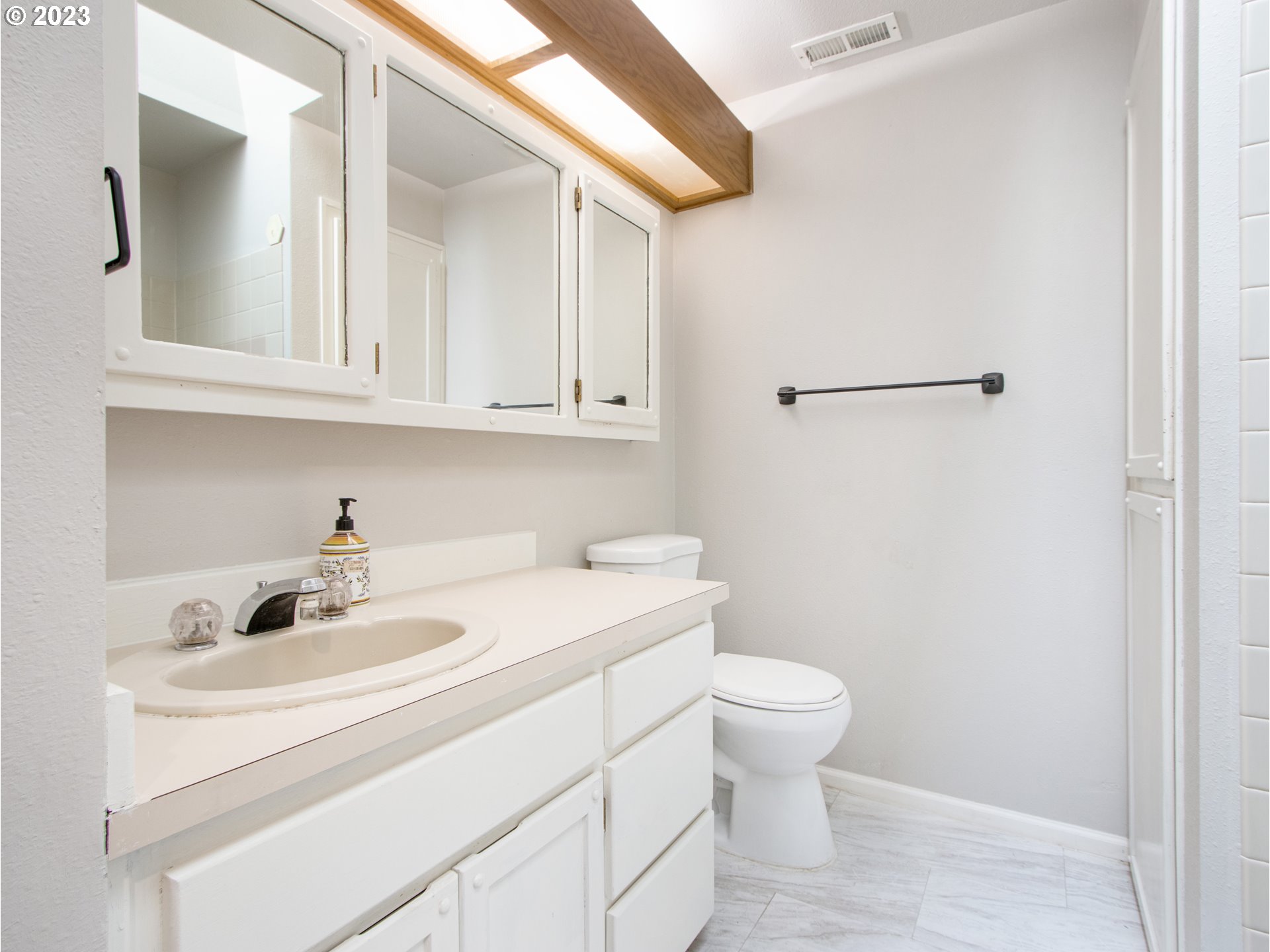 2883 Elysium Avenue Eugene, OR 97401 - Photo 12 of 21 a bathroom with a sink a toilet and a mirror