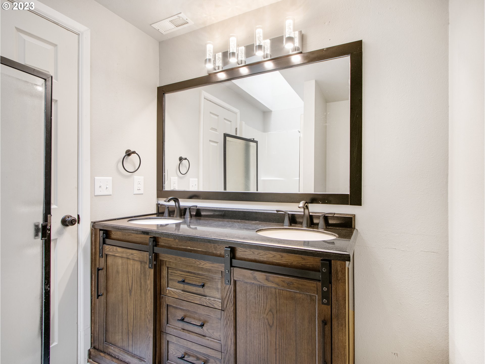 2883 Elysium Avenue Eugene, OR 97401 - Photo 14 of 21 a bathroom with a double vanity sink and a mirror