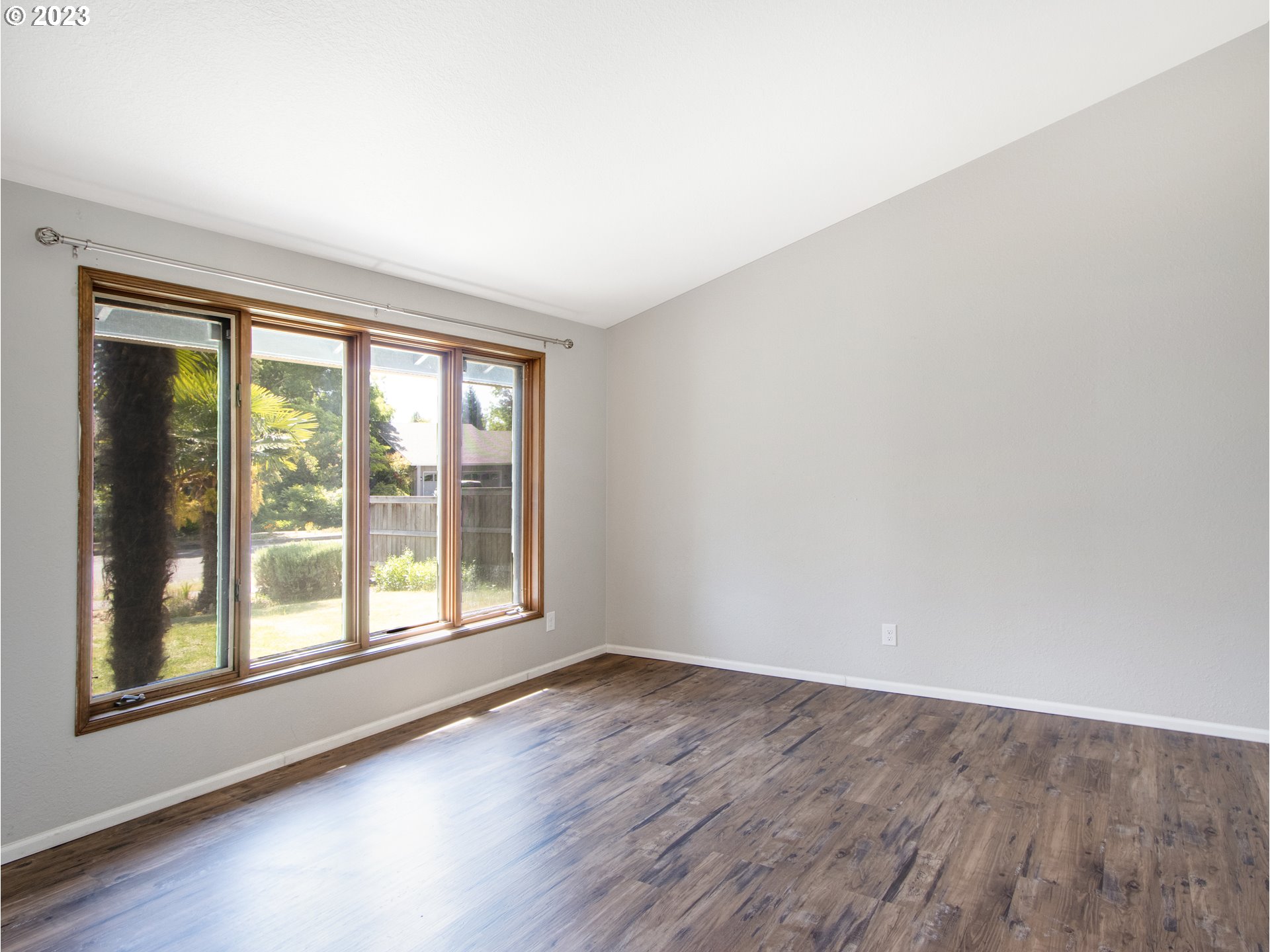 2883 Elysium Avenue Eugene, OR 97401 - Photo 5 of 21 wooden floor in an empty room with a window