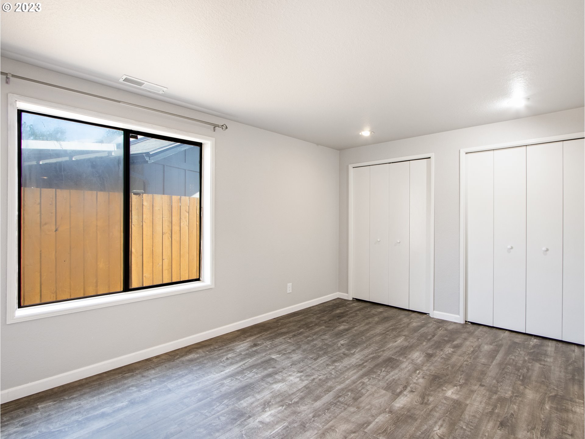 2883 Elysium Avenue Eugene, OR 97401 - Photo 8 of 21 a view of an empty room with wooden floor and a window