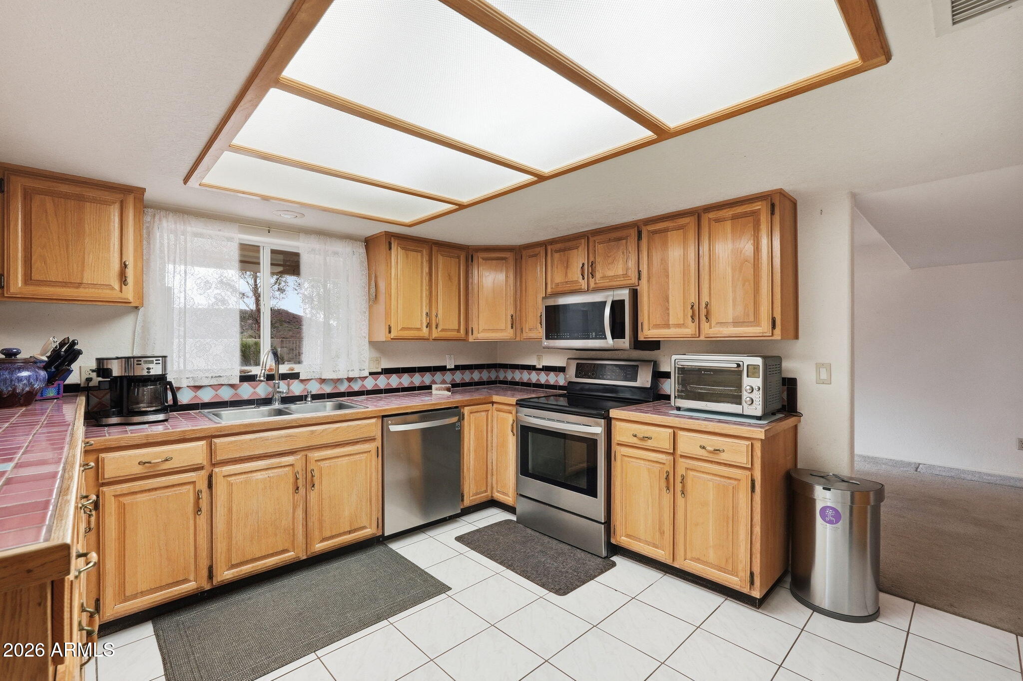 428 Camino Canoa Rio Rico, AZ 85648 - Photo 16 of 56 a kitchen with stainless steel appliances granite countertop a sink and cabinets