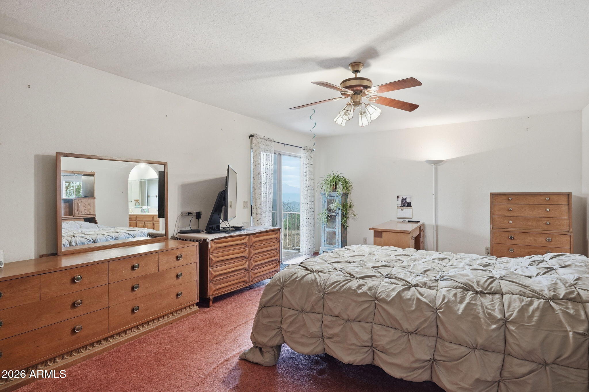 428 Camino Canoa Rio Rico, AZ 85648 - Photo 25 of 56 a bedroom with a large bed and a chandelier