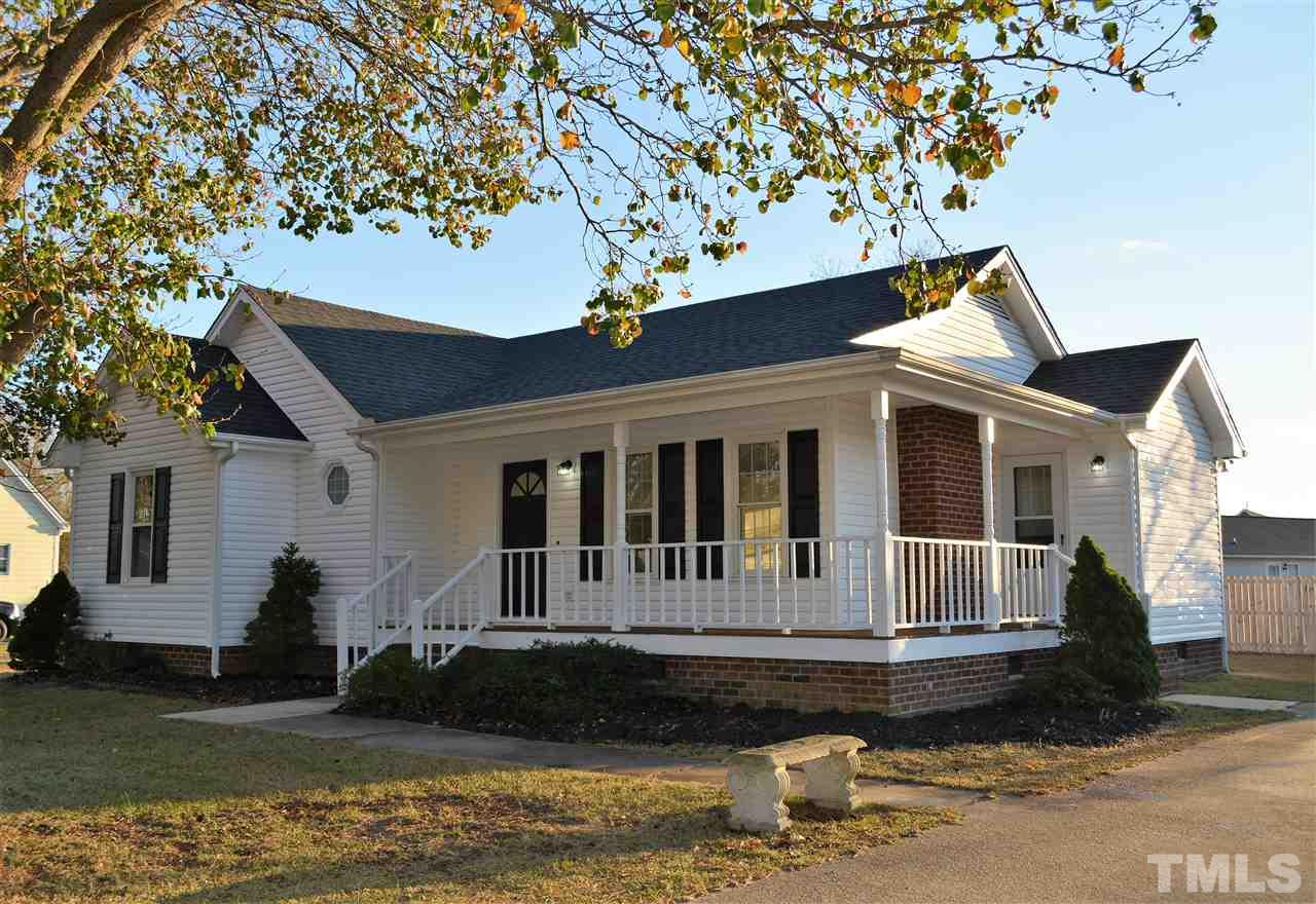 1603 Friendly Road Dunn, NC 28334 - Photo 2 of 24 View of the wrap around covered porch & bonus 2nd entrance. The lot has 2 beautiful mature trees and the rear of the large flat lot is fenced.