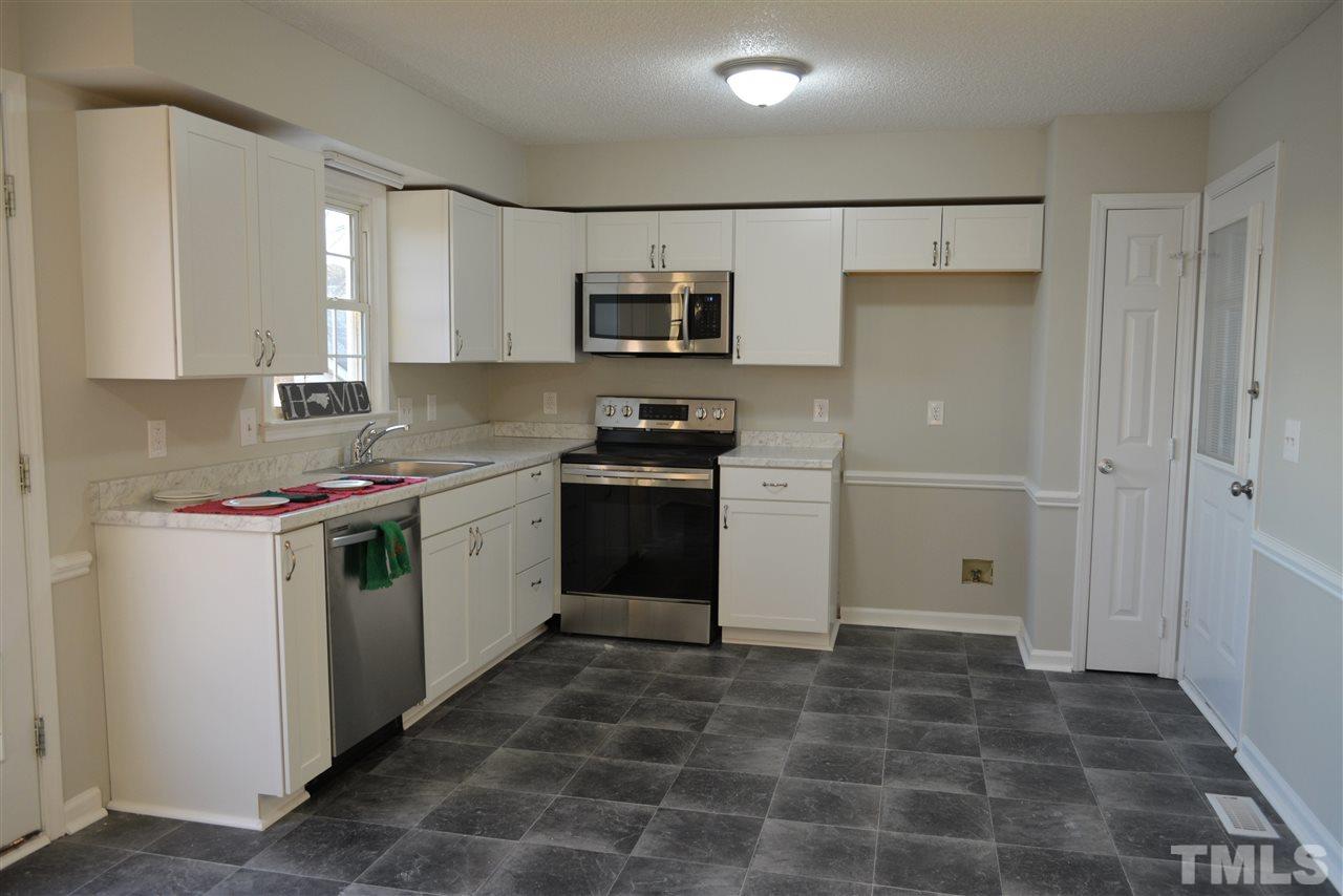 1603 Friendly Road Dunn, NC 28334 - Photo 4 of 24 New designer paint, new flooring, new cabinets & counter tops, new sink & faucet, new stainless appliances.