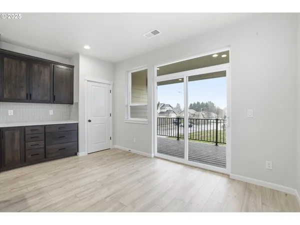 a view of wooden floor and cabinets in a room