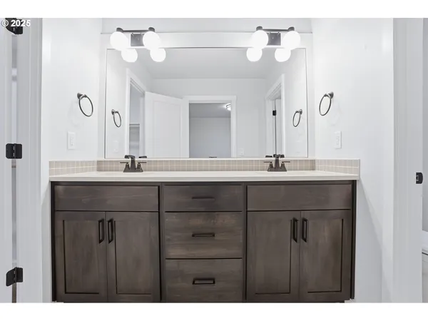 a bathroom with a sink vanity and a mirror