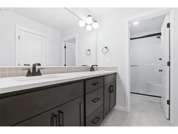a bathroom with a double vanity sink mirror and