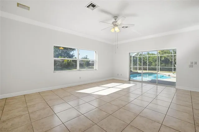 a spacious bedroom with a bed and a flat screen tv
