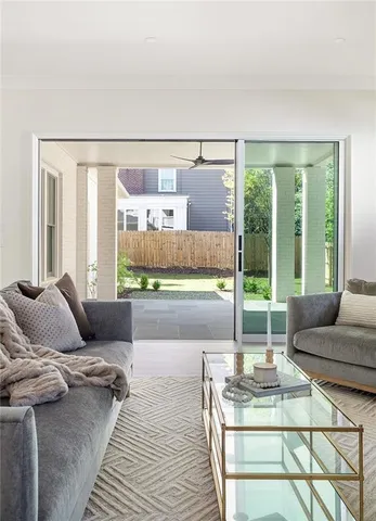 a living room with furniture and a floor to ceiling window