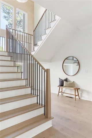 a view of a hallway with wooden floor and workspace